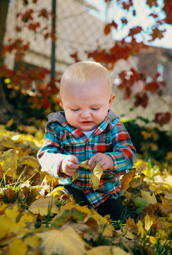 baby playing with leaves