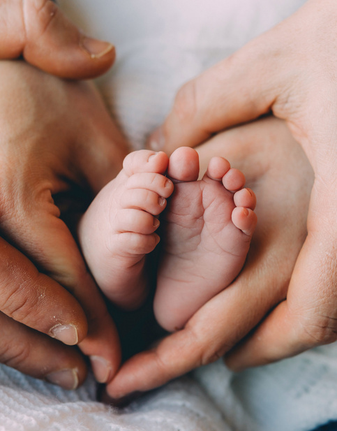 dad holding baby feet