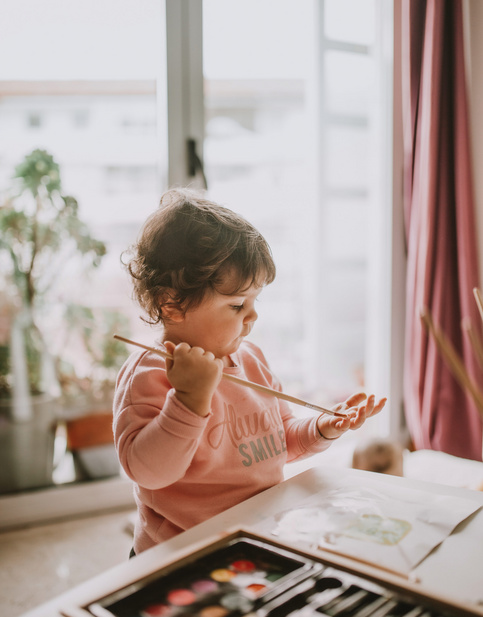 toddler with paintbrush